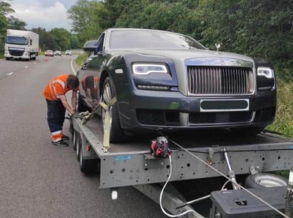 The stricken Rolls-Royce is loaded up ready for recovery on the A43 near Brackley