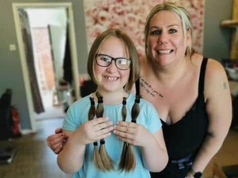 Ava Greenwood, eight, with her locks of hair freshly cut by hairdresser Samantha Parry from Shape Upz in The Springs Walk, Northampton