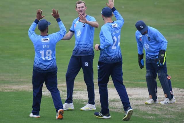 Tom Taylor is congratulated after claiming one of his two wickets in Sunday's loss to Glamorgan. He also hit an unbeaten 65 with the bat