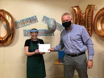 Maureen receiving her long-service award from CEO, Mark Fox
