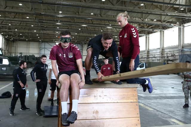 Joseph Mills, Aaron McGowan and manager Jon Brady take part in a team-building exercise.