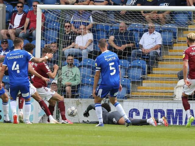 Jon Guthrie scores his first Cobblers goal, poking in at the second time of asking after his initial header was saved. Picture: Pete Norton.