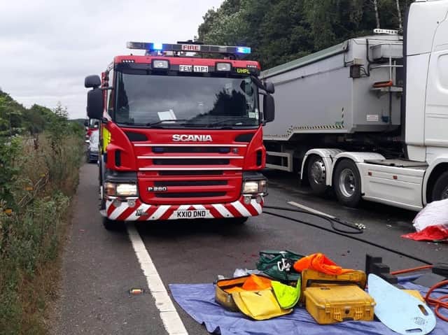 Firefighters worked to free the trapped woman on the A43 near Kettering on Tuesday morning