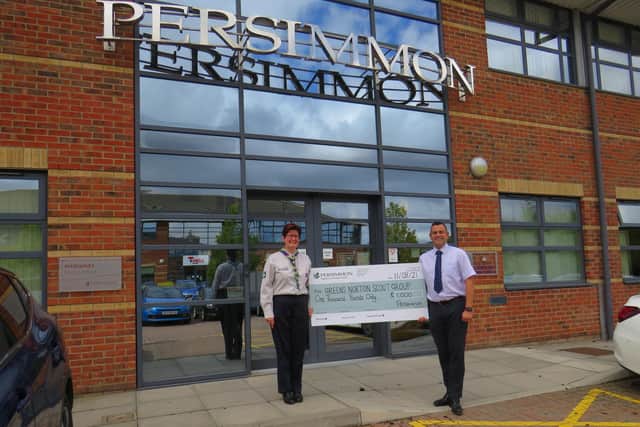 Davina Bowmer from Greens Norton Scout Group receives £1,000 of Building Futures funding from Simon McDonald, Persimmon Homes regional divisional director for Central.