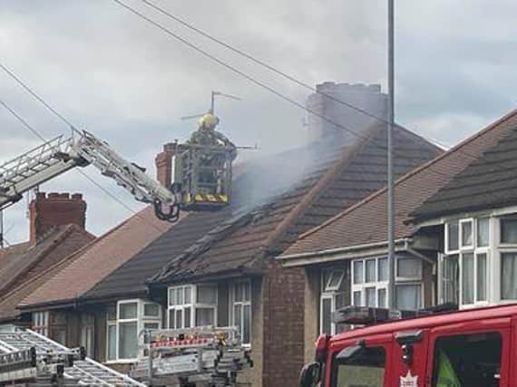 Firefighters tackle flames in the roof of the property in St Andrew's Road