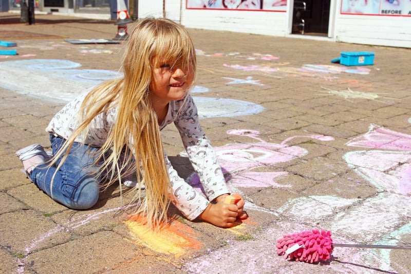 Children enjoying their time getting creative with chalks on Littlehampton High Street. Photo by Derek Martin Photography