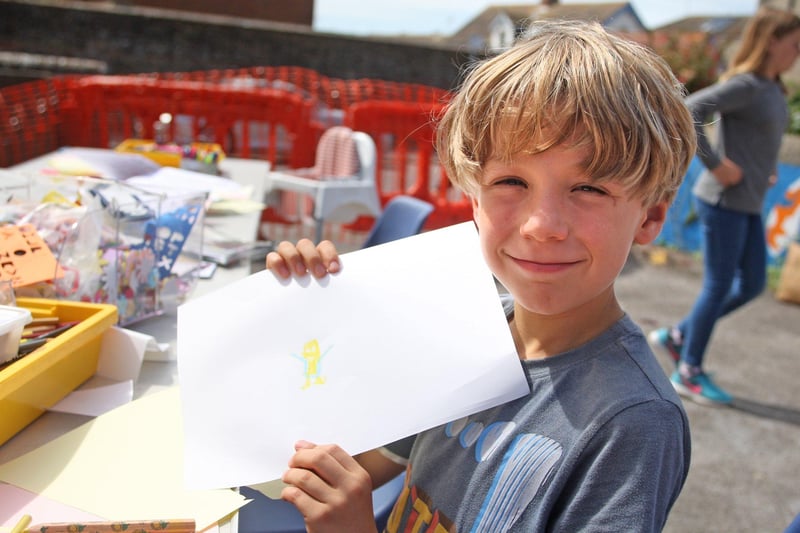 Ryley Smith-Bayley, age eight, proud of his creation. Photo by Derek Martin Photography
