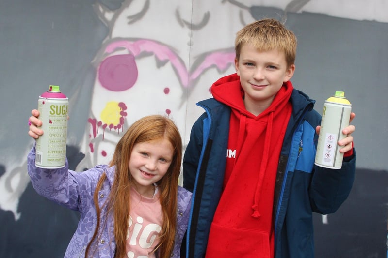 Esme Morter, age 11, and her brother Jude, age 11, enjoyed spray painting the mural. Photo by Derek Martin Photography