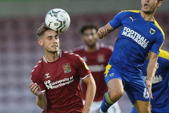 Cobblers striker Danny Rose battles for the ball against AFC Wimbledon (Pictures: Pete Norton)