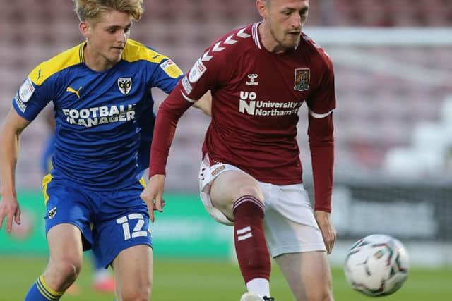 Cobblers midfielder Paul Lewis in possession for the Cobblers against AFC Wimbledon
