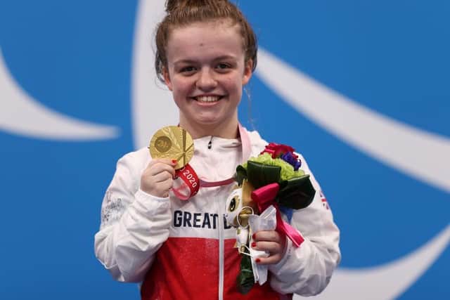 A delighted Maisie Summers-Newton shows off her Paralympic gold medal won in Tokyo on Thursday morning