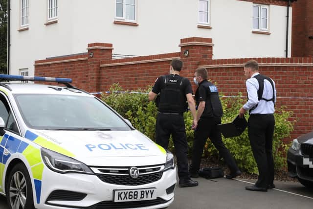 Officers outside the house in Slate Drive