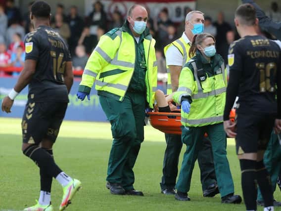 Joseph Mills is stretchered off the pitch. Picture: Pete Norton.