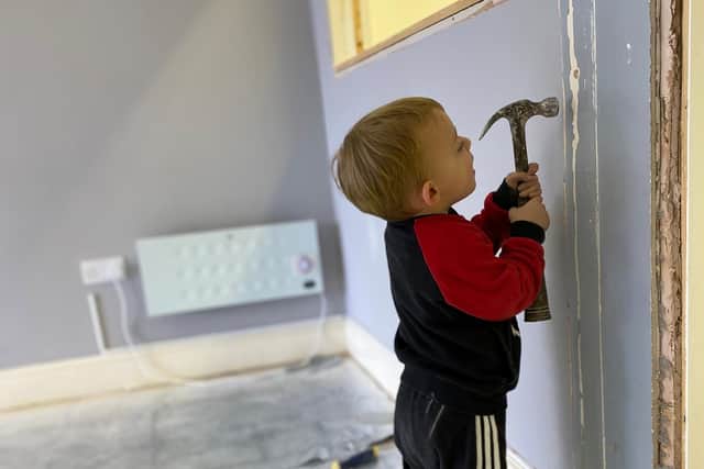 Emily's son helping out with renovations.