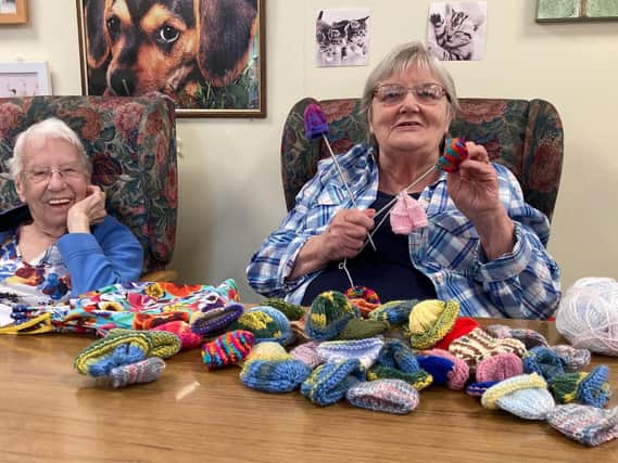 Christa (left) and Jean Stephens (right) knitting little hats for Age UK Northamptonshire.