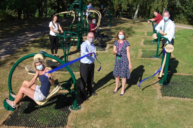 KGH’s director of human resources Paula Kirkpatrick cuts the ribbon to open the outdoor gym. She is pictured with staff and Wicksteed Leisure representatives in the gym.