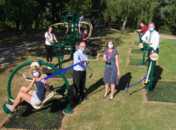 KGH’s director of human resources Paula Kirkpatrick cuts the ribbon to open the outdoor gym. She is pictured with staff and Wicksteed Leisure representatives in the gym.