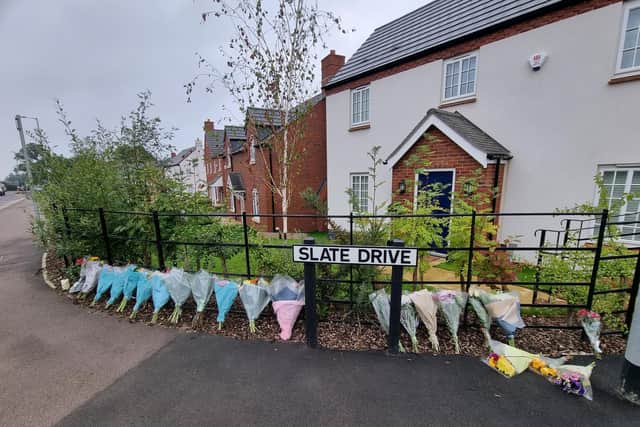 Floral tributes left outside the house.