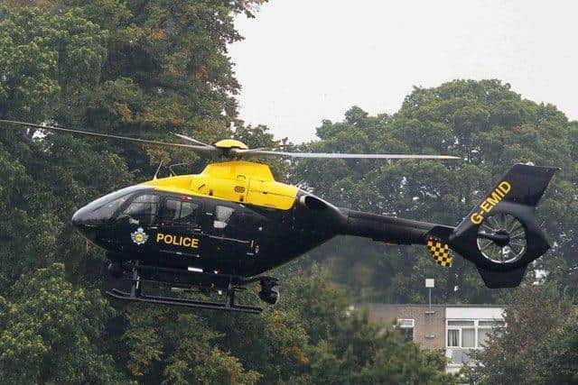 A man has been charged after a laser pointer was shone at a police helicopter.