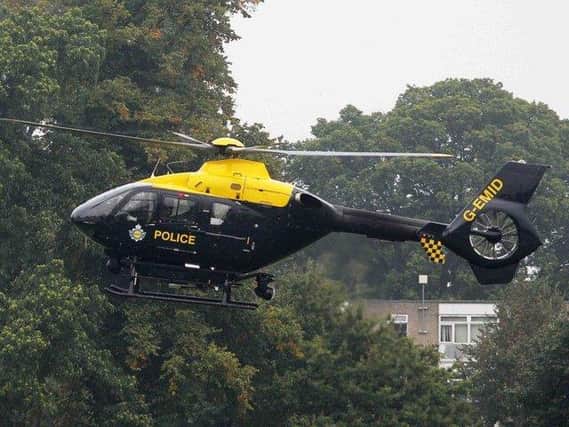 A man has been charged after a laser pointer was shone at a police helicopter.