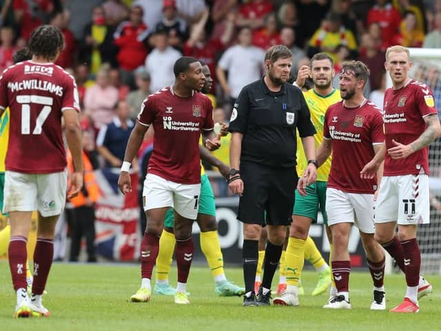 The Cobblers players remonstrate with referee Brett Huxtable after the late chalking off of Danny Rose's first-half goal (Pictures: Pete Norton)