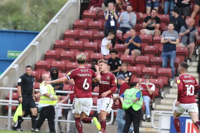 Fraser Horsfall celebrates with Sam Hoskins after netting the Cobblers' late equaliser against Swindon Town on Saturday (Picture: Pete Norton)