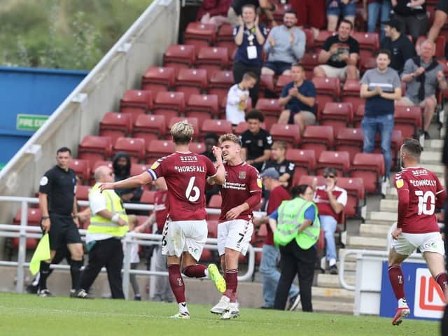 Fraser Horsfall celebrates with Sam Hoskins after netting the Cobblers' late equaliser against Swindon Town on Saturday (Picture: Pete Norton)