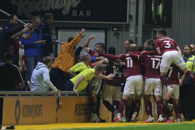 Jon Brady loved this picture of the Cobblers players and fans celebrating Jon Guthrie's winning goal at Newport County last week