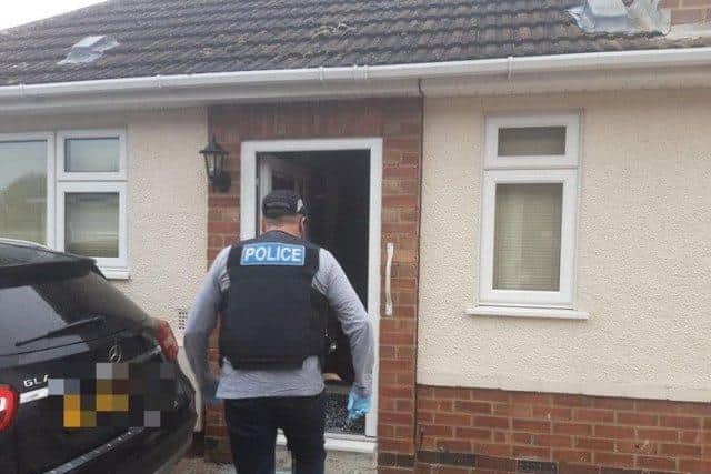 Police smash their way into Matthew Hall's house.