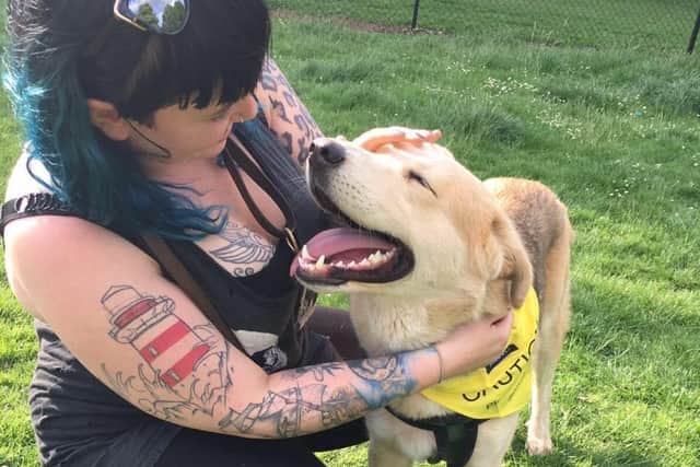 Lizzy Folwell-Murray with a dog she looks after professionally. The dog is not the one with her husband at the time of the incident.