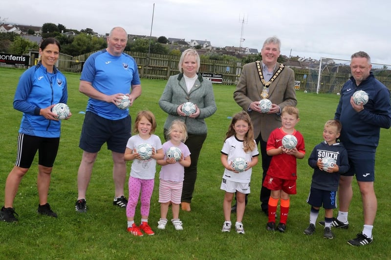 The Mayor of Causeway Coast and Glens Borough Council, Councillor Richard Holmes and Chairperson of Council’s NI 100 Working Group, Councillor Michelle Knight-McQuillan with Adrian, Jonathan and Suzanne from Portstewart Football Club and some of the youngest competitors at the summer camp