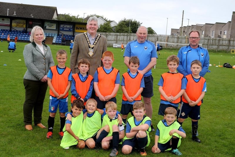 The Mayor of Causeway Coast and Glens Borough Council, Councillor Richard Holmes, and Chairperson of Council’s NI 100 Working Group, Councillor Michelle Knight-McQuillan with James and Adrian from Portstewart Football Club and the young footballers at the Football Summer Camp funded by Council’s NI 100 Centenary Small Grants Scheme