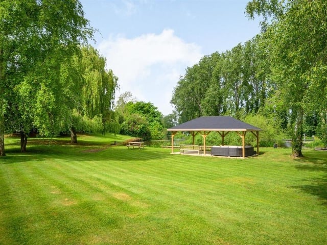 This Victorian home has a tennis court, huge gardens and a private mooring on the River Nene.