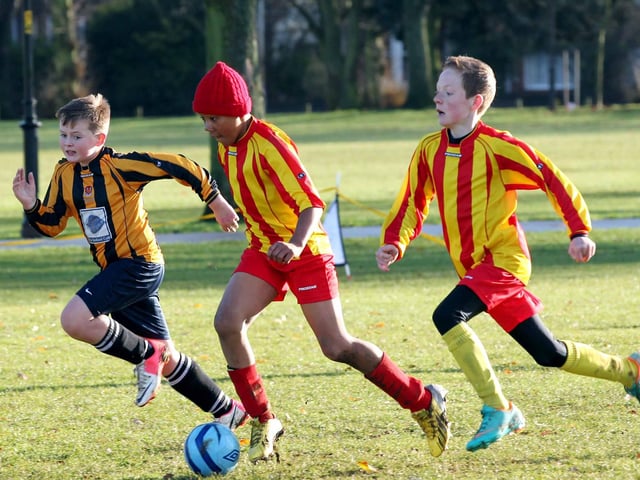 Youth Football action on the Racecourse, Northampton between FFA (yellow and red) and Parklands Tigers (yellow and black) in 2012.