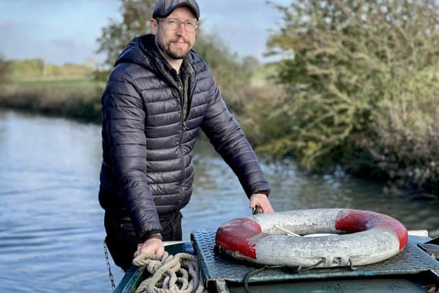 "Canal Boat Diaries" presenter Robbie Cumming on his narrowboat "Naughty Lass"