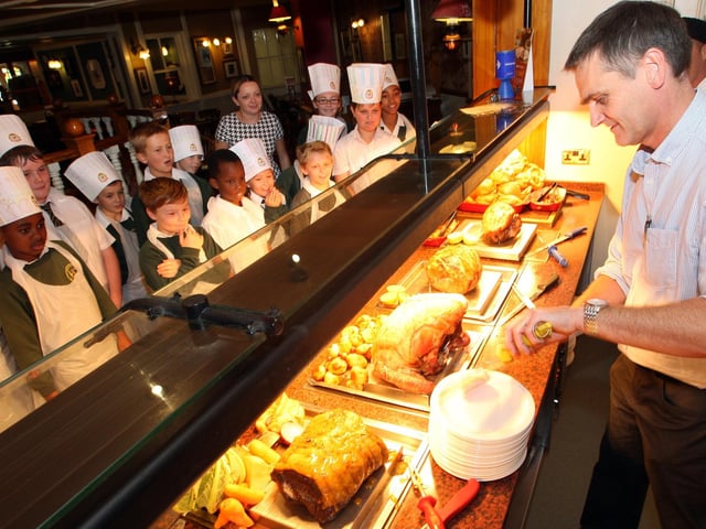Northampton, Toby Carvery East Hunsbury primary school taking part in Chef's School: Year six Teacher Graham Rogers, tries his hand at carving.