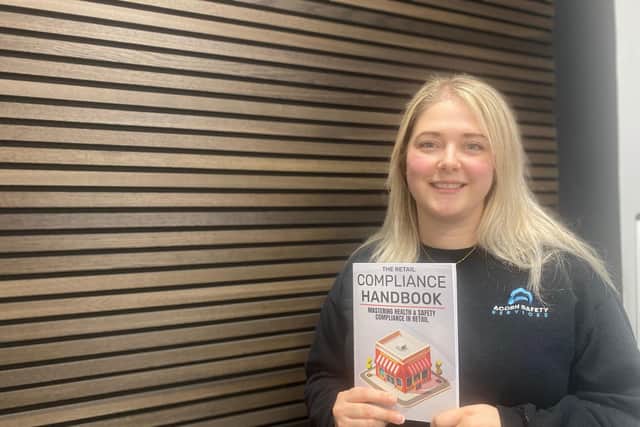 Zeynep Guzelkasap of Acorn Safety Services, pictured with The Retail Compliance Handbook.