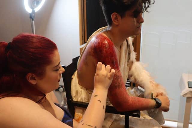 Rebecca Cassettari applies live prosthetics to her model.