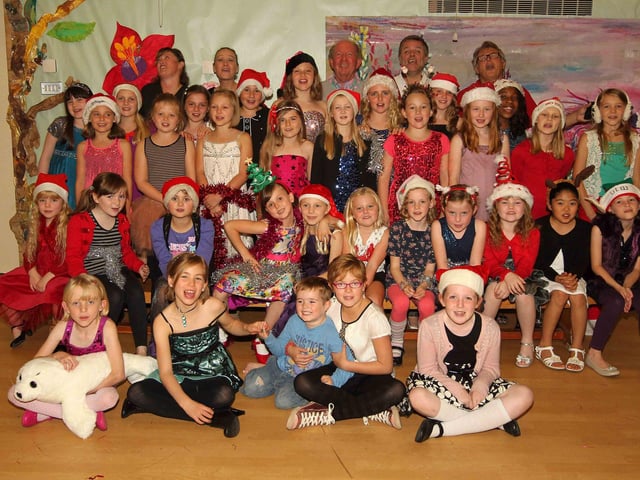 Children making a Christmas record at Nicholas Hawksmoor School, in aid of Lewis Wares, who needs £50,000 for an operation, Tony Hadley from Spandau Ballet will also sing on the record. Emma Wares, Lewis' Mum, Kat Stephens, singing school teacher, Pete Langford from the Barron Knights, Keith Bessey, producer and Stewart Blandamer who wrote the song, with the children who are recording the song and Lewis Wares, 5 and his sister Lily Wares, 8, (front centre).