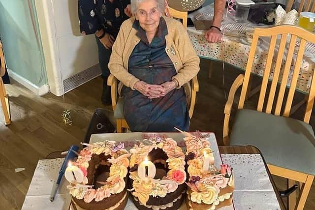 Vera celebrating her 100th birthday with her grandchildren. (left to right- Georgie Lamb, Vera Harman, Simon Lamb)