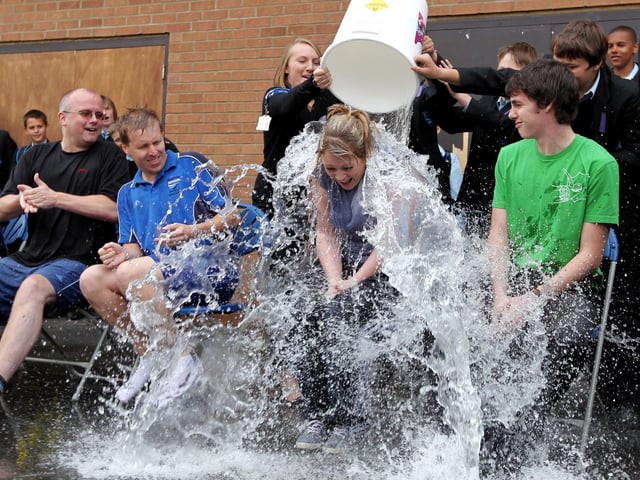 Duston School, Berrywood Road, fundraising week for school in Gambia. Teacher Emma Chambers getting drenched by pupils.