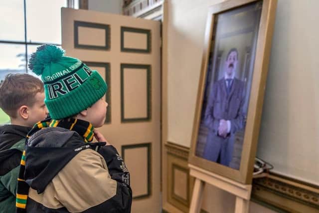 Young children look up at Delapré Abbey's Bouverie installation.