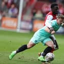Sam Hoskins goes to ground under the challenge of Brendan Wiredu of Fleetwood Town during Saturday's Sky Bet League One match at Highbury Stadium on April 13, 2024 in Fleetwood, England. (Photo by Pete Norton/Getty Images)