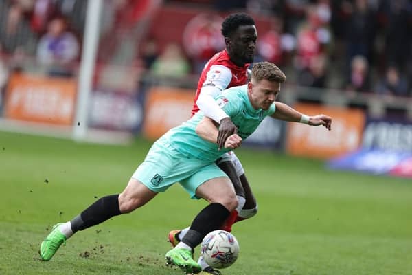Sam Hoskins goes to ground under the challenge of Brendan Wiredu of Fleetwood Town during Saturday's Sky Bet League One match at Highbury Stadium on April 13, 2024 in Fleetwood, England. (Photo by Pete Norton/Getty Images)
