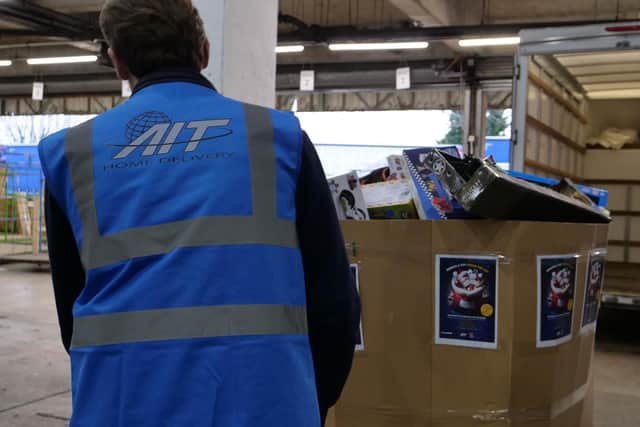 AIT Home Delivery loading a selection of the donated toys.
