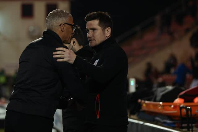 Lee Bell shakes hands with then-Hartlepool manager Keith Curle