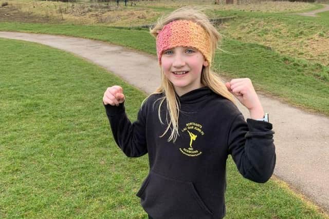 Alicja Janczak, 8, is on day 11 of jogging one mile and doing 20 push ups and sit ups every morning.