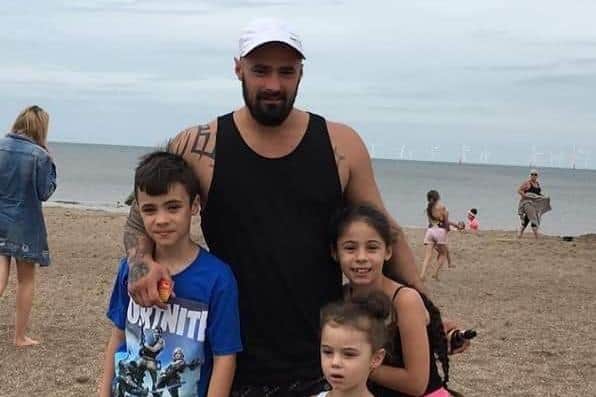 Jaime at the beach with his children