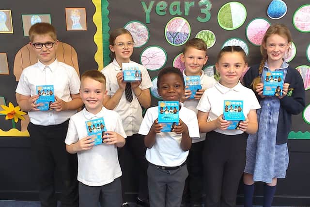 Pupils from The Arbours Primary Academy with their money boxes.
