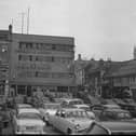 Northampton Market Square circ 1964 showing Chron building and Emporium Arcade, which was demolished in the 1970s. When there was no market, the square became a popular free car park.